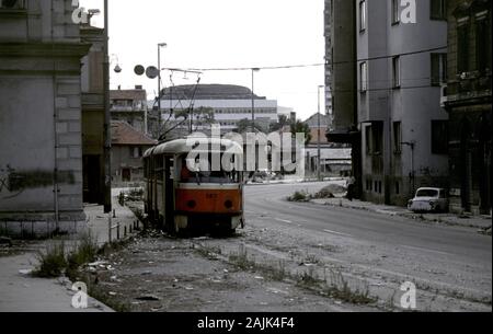 17th August 1993 During the Siege of Sarajevo: children play inside a wrecked tram on Hiseta Street (formerly called Branka Radicevica). Stock Photo