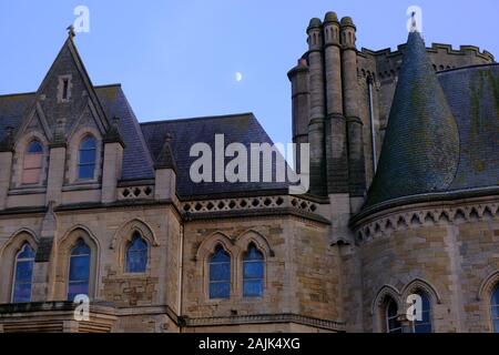 Aberystwyth Ceredigion Wales UK January 04 2020: Moon rising over the Gothic Architecture of Aberystwyth University Stock Photo