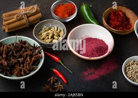 Colorful spice and condiment in bowls Stock Photo