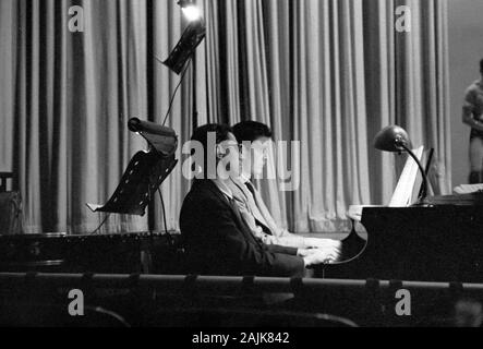John Cage and David Tudor in performance in New York City, 1957, probably performing Winter Music. The exact date and venue are unknown.