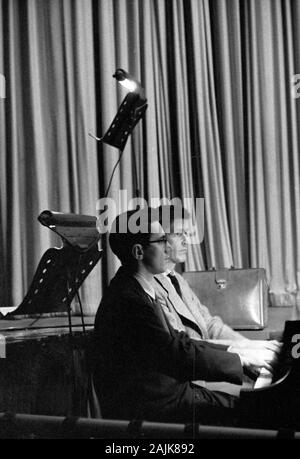 John Cage and David Tudor in performance in New York City, 1957, probably performing Winter Music. The exact date and venue are unknown.