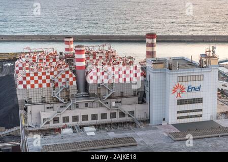 Genoa, Genova, Italy: Enel old coal power station nearby Lanterna lighthouse in the port of Genoa, industrial landscape Stock Photo