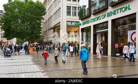 Father with his boys take a walk down the pedestrian shopping district in downtown Munich, Germany. Stock Photo