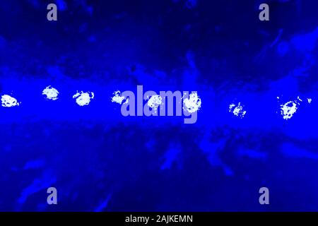 abstract dark blue blurred background - a series of lights shine through ice Stock Photo