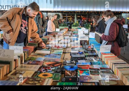 People browse at the Southbank Centre outdoor weekend book market, South Bank, London, UK Stock Photo