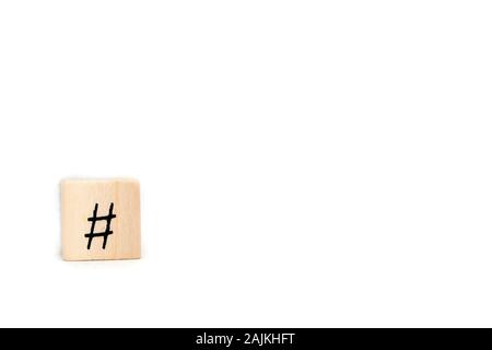 Wooden cube with hashtag isolated on white background, social media concept with space for text Stock Photo