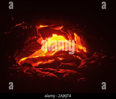 Scenic view of a part of a lava flow in the dark, the hot lava shows up in yellow and red shades - Location: Hawaii, Big Island, Kilauea volcano, Puna Stock Photo