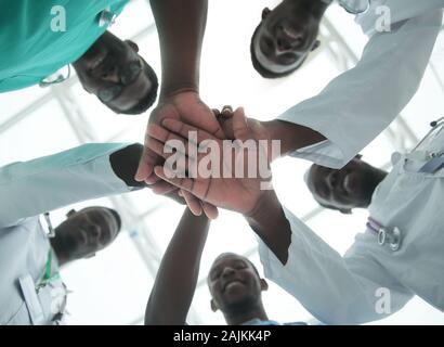 close up. international group of doctors putting their hands together Stock Photo