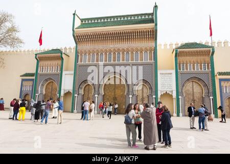 People on Place des Alaouites in front of the gates to Dar al-Makhzen (also known as Palais Royal or the Royal Palace) in Fes (Fez), Morocco Stock Photo
