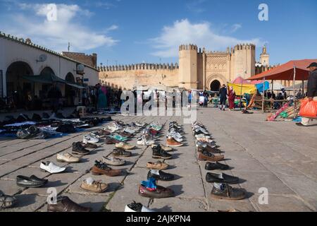 Footwear collection on the open-air market on Place Boujloud (also Place Bou Jeloud) and Bab Chorfa – one of the gates of Fes (Fez), Morocco Stock Photo