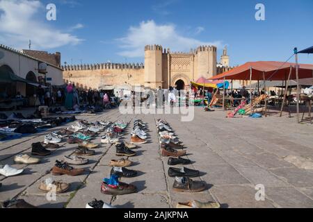 Footwear collection on the open-air market on Place Boujloud (also Place Bou Jeloud) and Bab Chorfa – one of the gates of Fes (Fez), Morocco Stock Photo