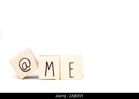 Wooden cube with a commercial At Sign symbol and the word Me isolated on white background, space for text Stock Photo