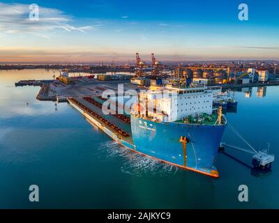The Cargo Ship is in the Port Burgas at the Loading . Aerial View from Drone at sunset. Location Burgas Town, Bulgaria Stock Photo