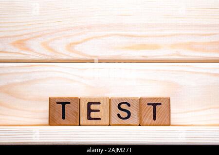 Test word made of wood background. Business concept. Test sign, exam, learning concept. Word test written with wooden cubes. Education quality control. Test background Stock Photo
