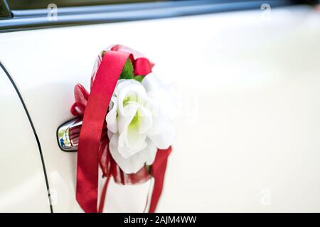 White wedding car decorated with fresh flowers. Wedding decorations Stock Photo