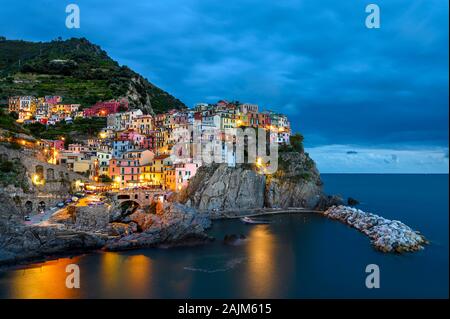 Night view of Manarola village, Cinque Terre, Italy. Blue hour after sunset. Stock Photo