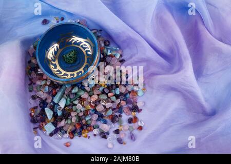 chakra healing crystals on pastel silk background Stock Photo