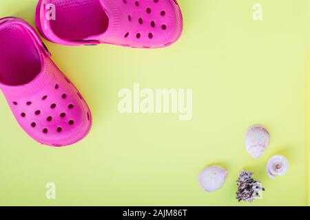 Colorful summer beachwear, flip flops, seashells,starfish on yellow background. Stock Photo