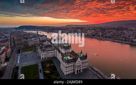 Budapest, Hungary - Aerial panoramic drone view of the Hungarian Parliament building on a winter afternoon with an amazing dramatic colorful gold and
