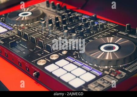 Disc Jockey mixing deck and turntables at night controls for mixing music for a party or disco Stock Photo