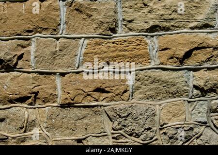Old stone building wall from a historic structure showing the pattern of the masonry Stock Photo