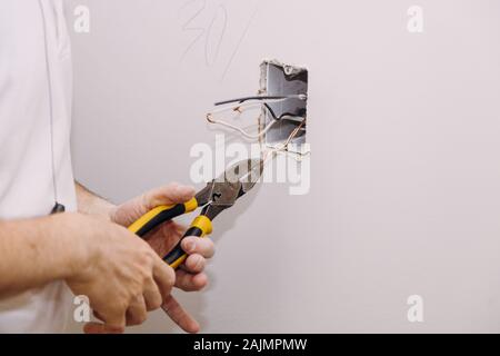 New electrical mounting of socket box, switch electrical outlets connector installed in plasterboard drywall in apartment is under construction Stock Photo