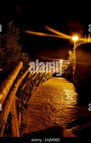Stairway at night down to beach Stock Photo