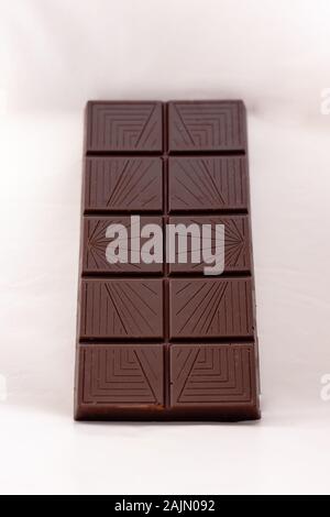 Dark chocolate with whole hazelnuts isolated on white background Stock Photo