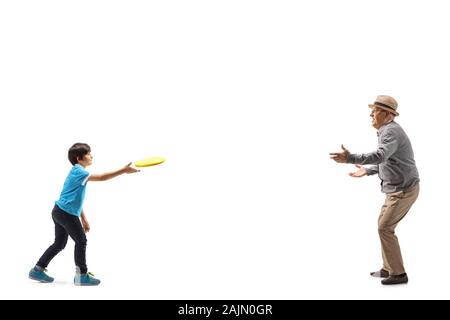 Full length shot of a grandson and grandfather playing  a game with throwing plastic disk isolated on white background Stock Photo