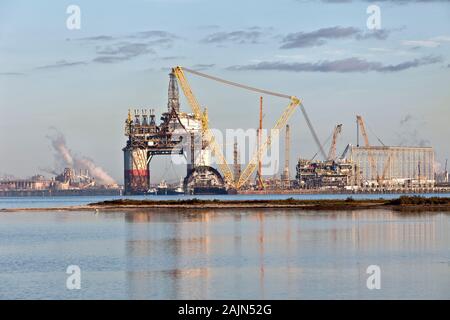 Construction of 'Big Foot' deepwater oil & gas platform nearing completion, swing booms, at dawn,  Ingleside Bay. Stock Photo