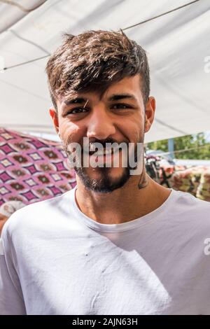 Bodrum, Turkey - September 24th 2019: Young Turkish man smiling for the camera. The town is a popular tourist destination.