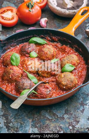 Vegan meatballs with tomato sauce in a skillet.  Plant based meat free alternative Stock Photo