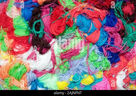 A colourful textured background with skeins of yarn bundled together. Stock Photo
