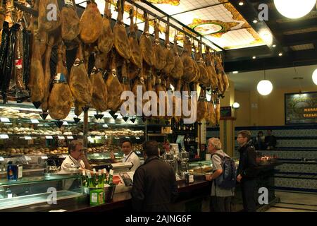 Seville Spain, people being served in local jamoneria Stock Photo