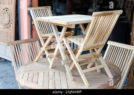 Set of wooden furniture - a table and two chairs. Showroom in a carpenter's shop with wood products. Bali, Jimbaran Stock Photo