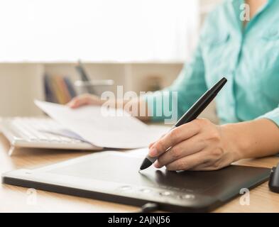 designers hand use mouse pen and computer working on new projects Stock Photo