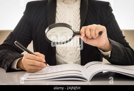 auditor or internal revenue service staff checking annual financial statements of company Stock Photo