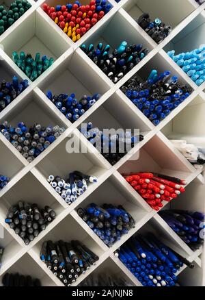 Colorful pens on shelf in stationery store Stock Photo by ©crPrin 167053992