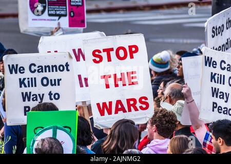 January 4, 2020 San Jose / CA / USA - Close up of Stop The Wars sign raised at the anti-war protest in front of the Cityhall in downtown San Jose; Stock Photo