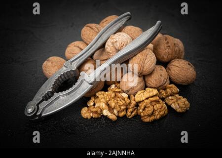 Walnut on over black slate stone background Stock Photo
