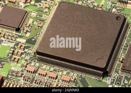 Macro of a tiny but powerful microchip mounted on a circuit board Stock Photo