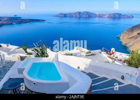 White buildings and hotels with panoramic view of Aegean Sea in Fira, Santorini, Greece Stock Photo