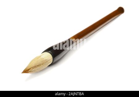 Traditional Chinese calligraphy brush lying on a white background Stock Photo