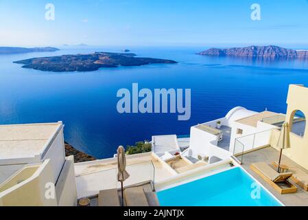 White buildings and hotels with panoramic view of Aegean Sea in Fira, Santorini, Greece Stock Photo