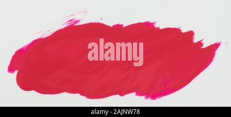 Glossy pink paint stain isolated on white background close up view Stock Photo