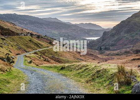 A rural mountain road in Snowdonia National Park in Wales over looking Llyn Gwynant Lake Stock Photo