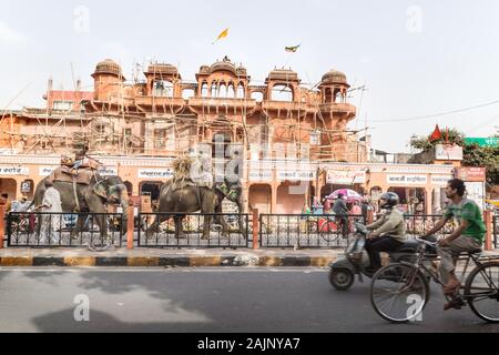 Jaipur, Rajasthan, India - 7 March 2012: Colorful painted elephants for the Holi Elephant festival riding through the busy traffic along a constructio Stock Photo