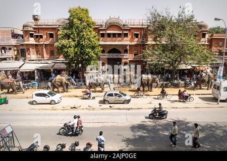 Jaipur, Rajasthan, India - 7 March 2012: Colorful painted elephants for the Holi Elephant festival riding through the busy traffic of the city center Stock Photo