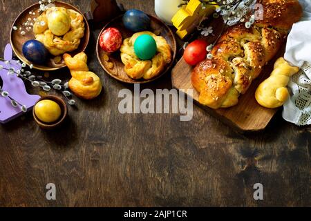 Easter holiday table. Easter cakes and colored eggs on a wooden table. Top view flat lay background. Copy space. Stock Photo