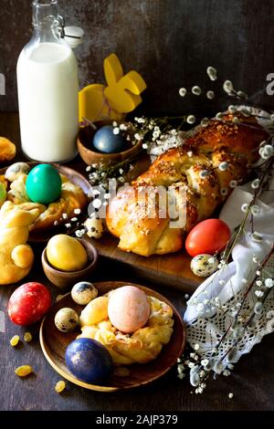 Easter holiday table. Easter cakes and colored eggs on a wooden table. Stock Photo